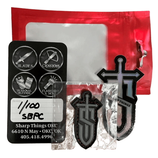 Sharp Things Emblem tactical PVC patch with sword design, displayed with art card and red packaging.
