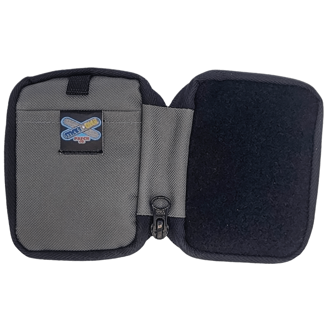 Back side of grey Micro Pouch with a logo patch and empty compartments.
