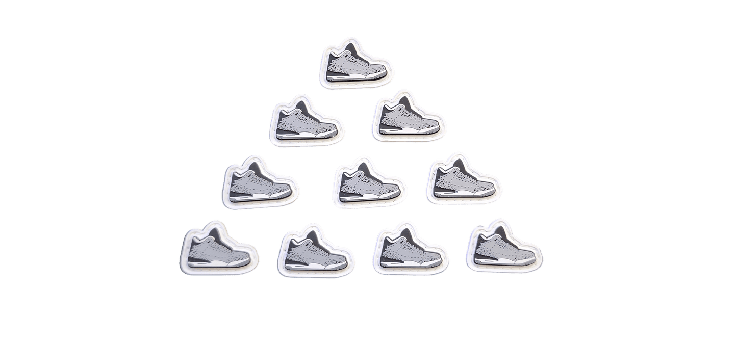 Multiple Wolf Grey V1 PVC patches arranged in a pyramid shape, depicting sneaker designs.